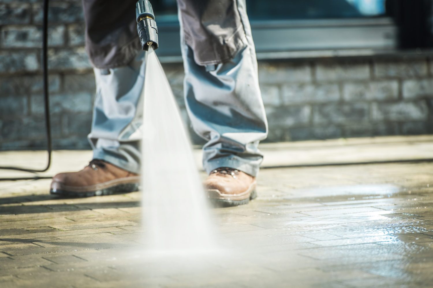 Men Using Pressure Washer For Driveway Cleaning.